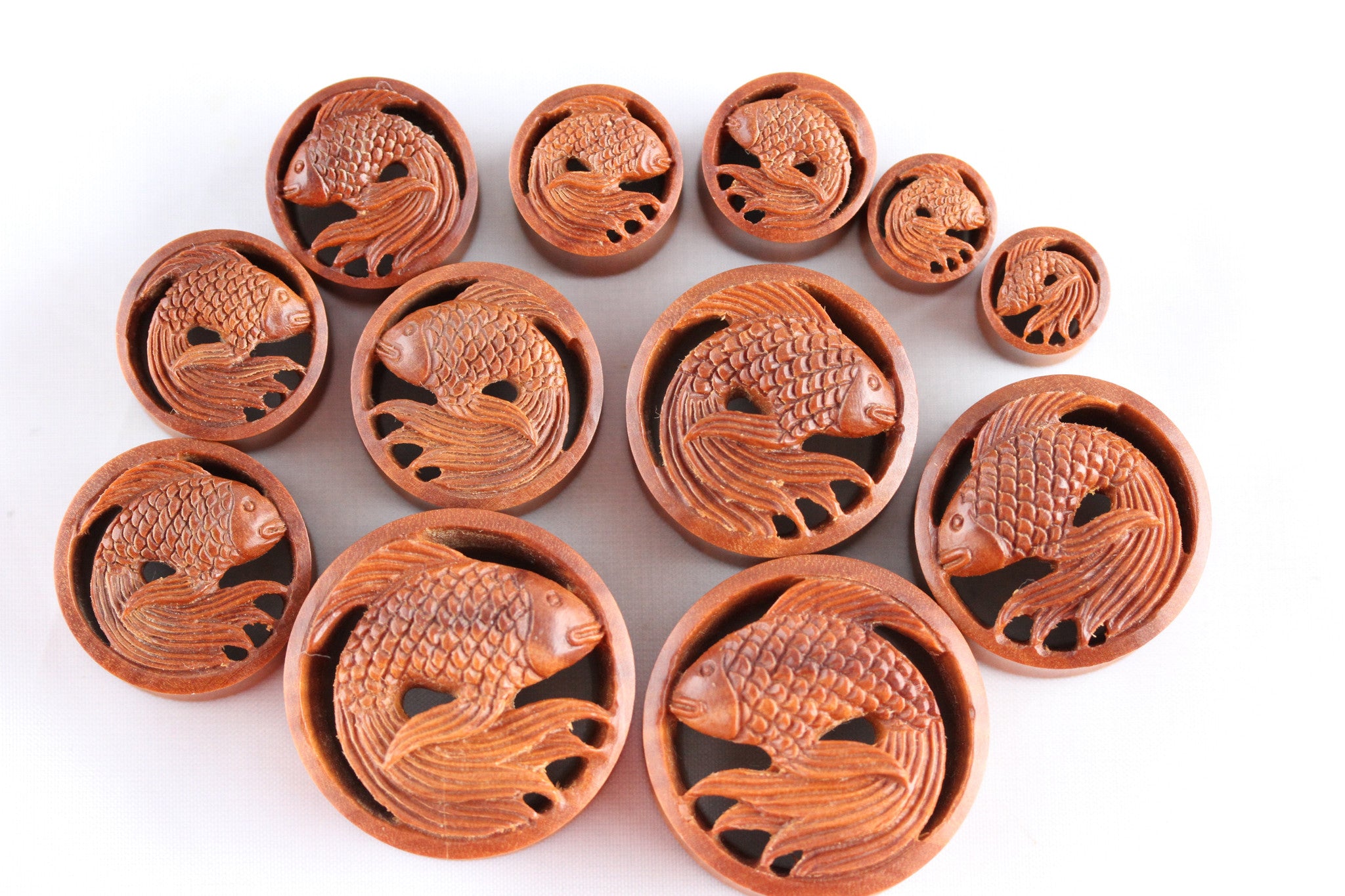 32 mm wood plugs filled with epoxy resin. Plugs with koi carps. Buddha plugs. Om outlet plugs. Meditative and pacified plugs