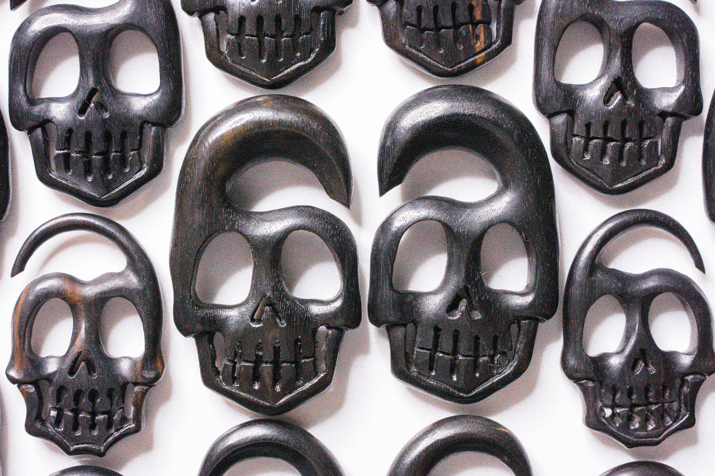 stretched ear skull wood plugs