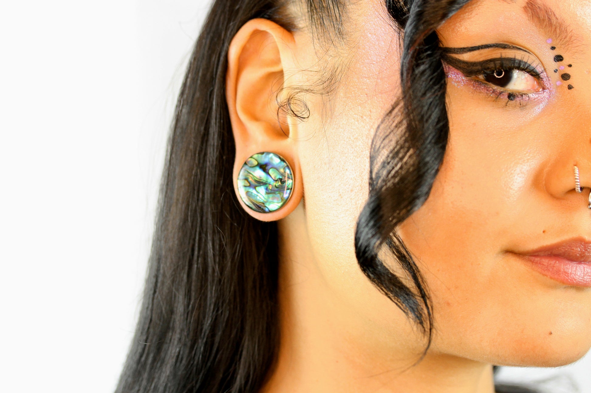 stretched ear plugs abalone